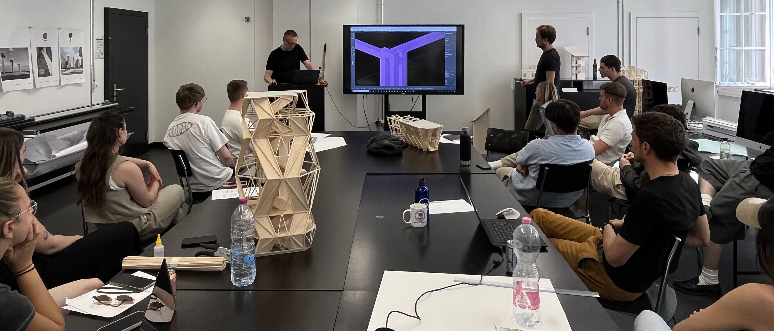 Entwurfspräsentation in der ArchitekturWerkstatt: Studierende stellen ihre Brücken- und Turmkonzepte digital vor und diskutieren die konstruktiven Details.