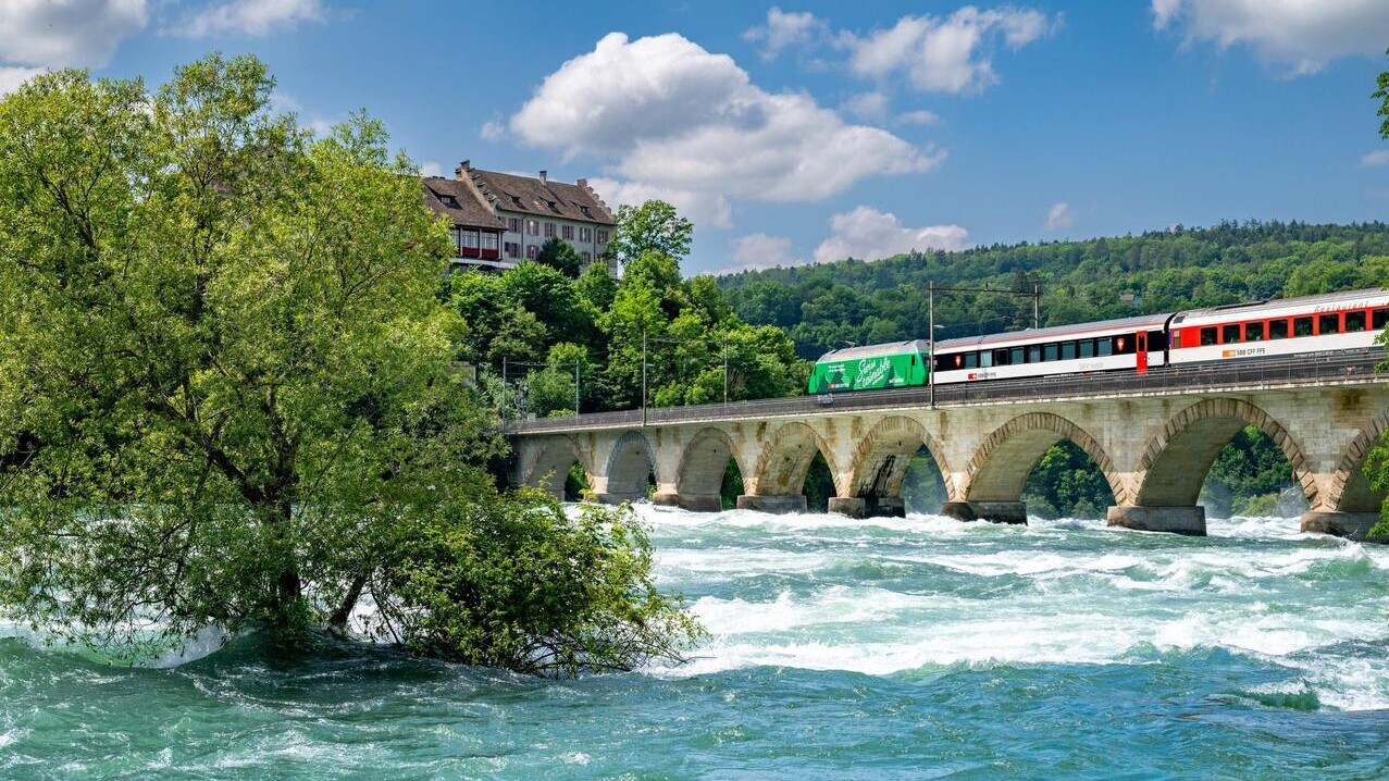 Swisstainable Lokomotive Re 460 auf Rheinbrücke.